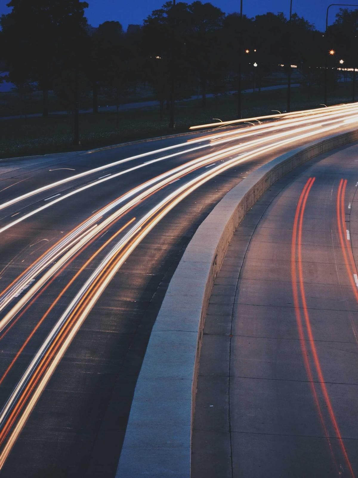 Long-exposure light trails across a motorway at night